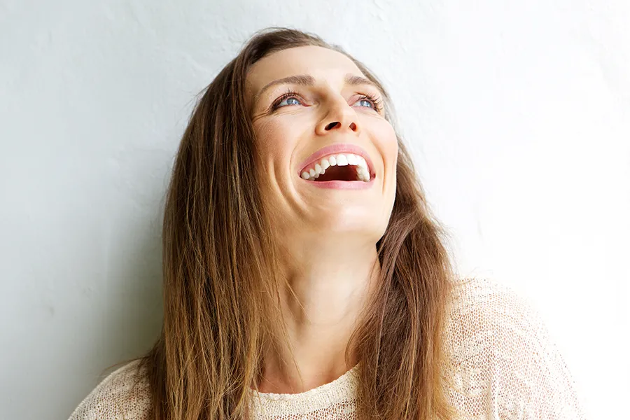 A middle-aged woman is smiling grandly while looking at the sky. Get FormaV Vaginal Rejuvenation Treatment by Dr. Lashea Davis Roland in Silver Spring.