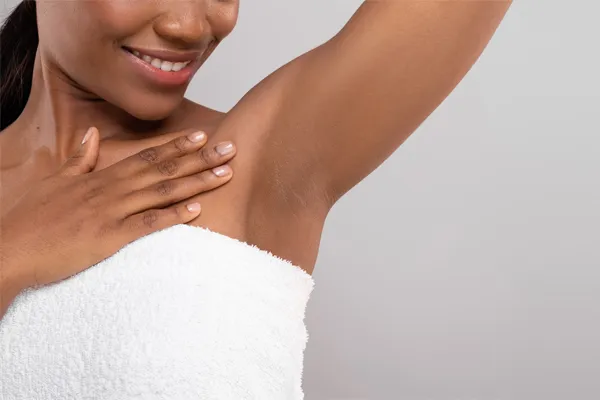 botox-for-excessive-sweating-Clinic Close up of an African American woman wrapped in a white towel showing her underarm area. Visit Botox® for excessive sweating specialist Dr. Lashea Davis Roland in Silver Spring.
