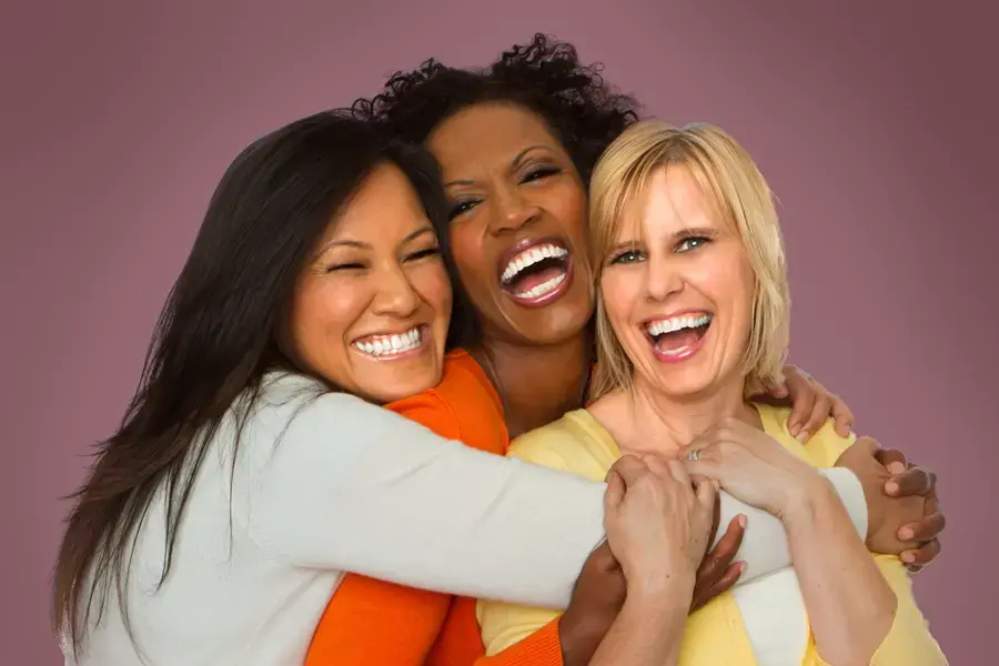 3 women hugging and laughing. Get treatment for Women's Health issues from Dr. Lashea Davis Roland in Silver Spring.
